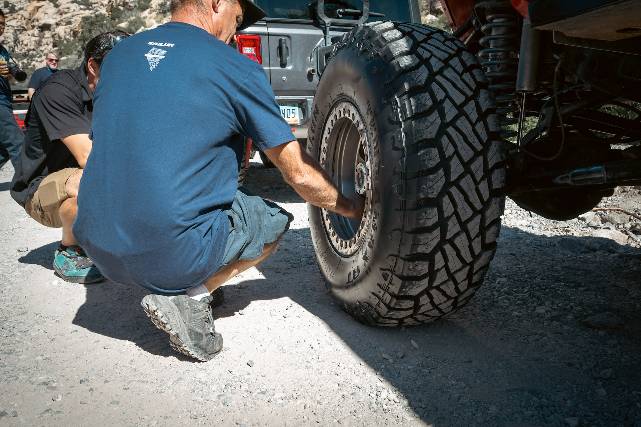 A service person changes a tire