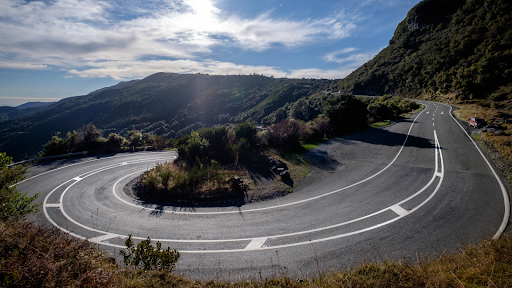 A winding road with a sharp hairpin turn in the mountains
