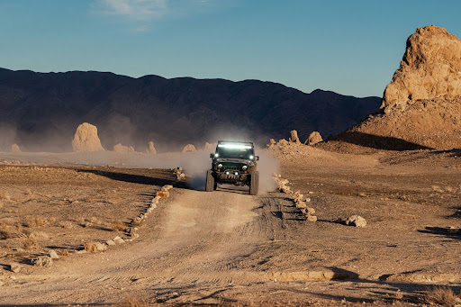a Jeep off-roading in a desert