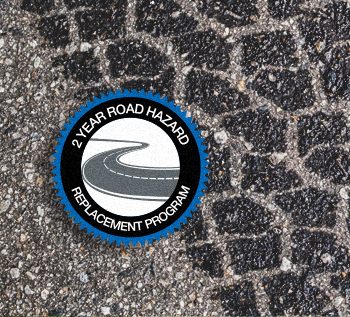 2 year road hazard replacement program badge on road with tread
